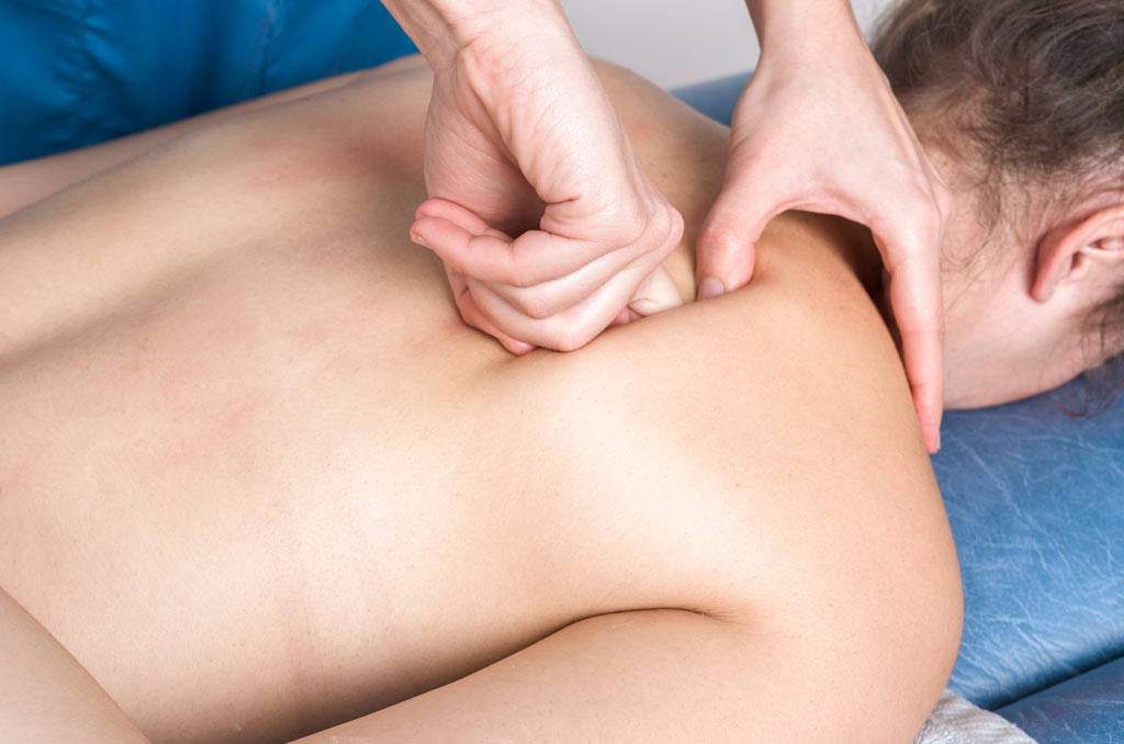 osteopath massaging back