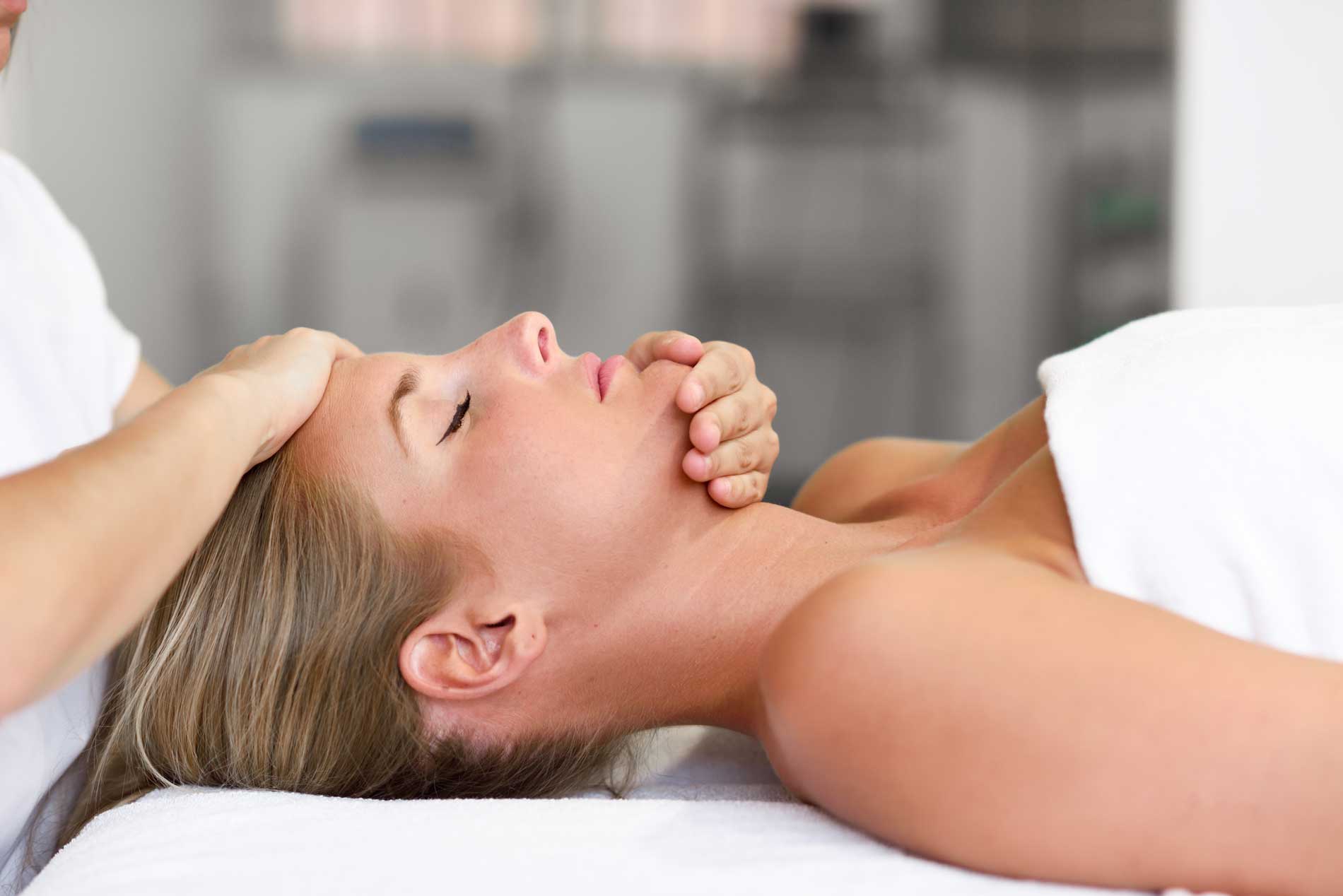 young-woman-receiving-head-massage osteopathy cranial therapy for headaches